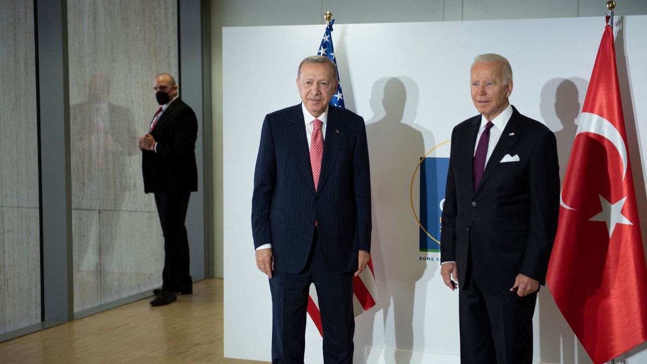 Turkey's President Recep Tayyip Erdogan and US President Joe Biden stand together before a meeting about the Iranian nuclear program during the G20 Summit at the Roma Convention Center La Nuvola on October 31, 2021, in Rome, Italy.