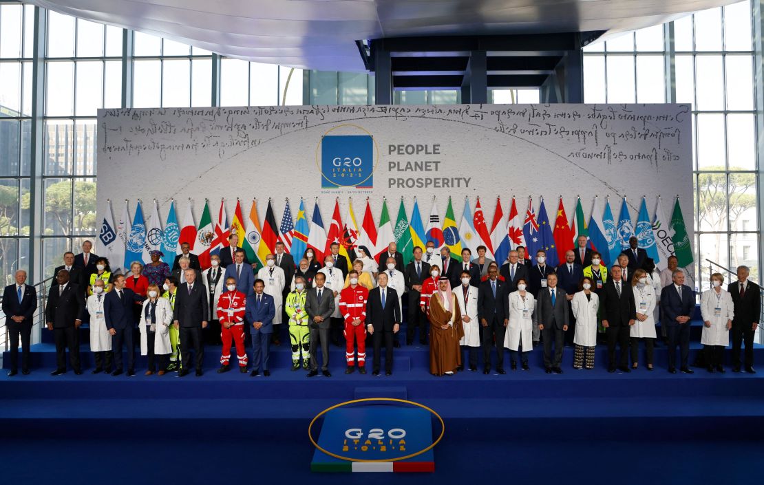 Italian Prime Minister Mario Draghi, center front, stands with the Italian medical team and world leaders as they gather for the official family photograph on day one of the G20 Summit at the convention center of La Nuvola, in Rome on Saturday, October 30, 2021.