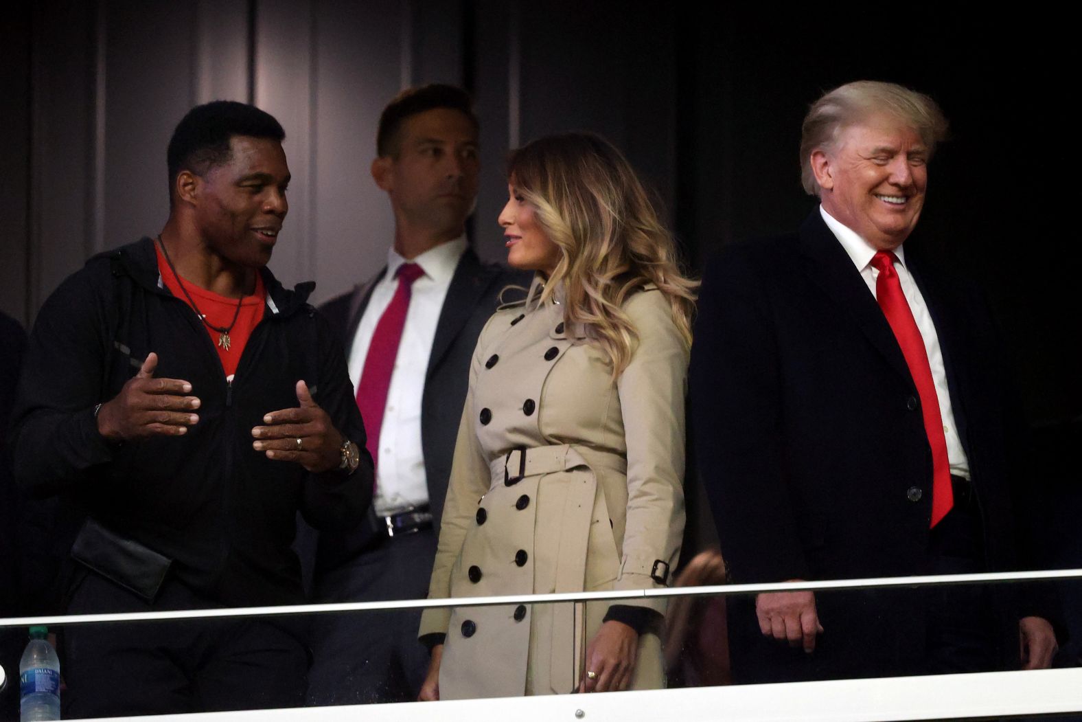 Former NFL star Herschel Walker, who is <a href="index.php?page=&url=https%3A%2F%2Fwww.cnn.com%2F2021%2F10%2F27%2Fpolitics%2Fherschel-walker-mitch-mcconnell-endorsement-georgia%2Findex.html" target="_blank">running for a US Senate seat in Georgia,</a> interacts with former first lady Melania Trump and <a href="index.php?page=&url=https%3A%2F%2Fwww.cnn.com%2Fsport%2Flive-news%2Fworld-series-2021-braves-astros-game-4%2Fh_a1ea7d6db9180698e548450bf54bed0e" target="_blank">former President Donald Trump</a> prior to Game 4. Trump's support of Walker, which came initially over reservations from much of the GOP establishment, has given the former running back a boost ahead of next year's primary.