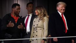 ATLANTA, GEORGIA - OCTOBER 30:  Former football player and political candidate Herschel Walker interacts with former first lady and president of the United States Melania and Donald Trump prior to Game Four of the World Series between the Houston Astros and the Atlanta Braves Truist Park on October 30, 2021 in Atlanta, Georgia. (Photo by Elsa/Getty Images)