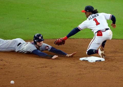 Kyle Tucker of the Astros steals second base before advancing to third as Braves second baseman Ozzie Albies misses the ball in the fifth inning.