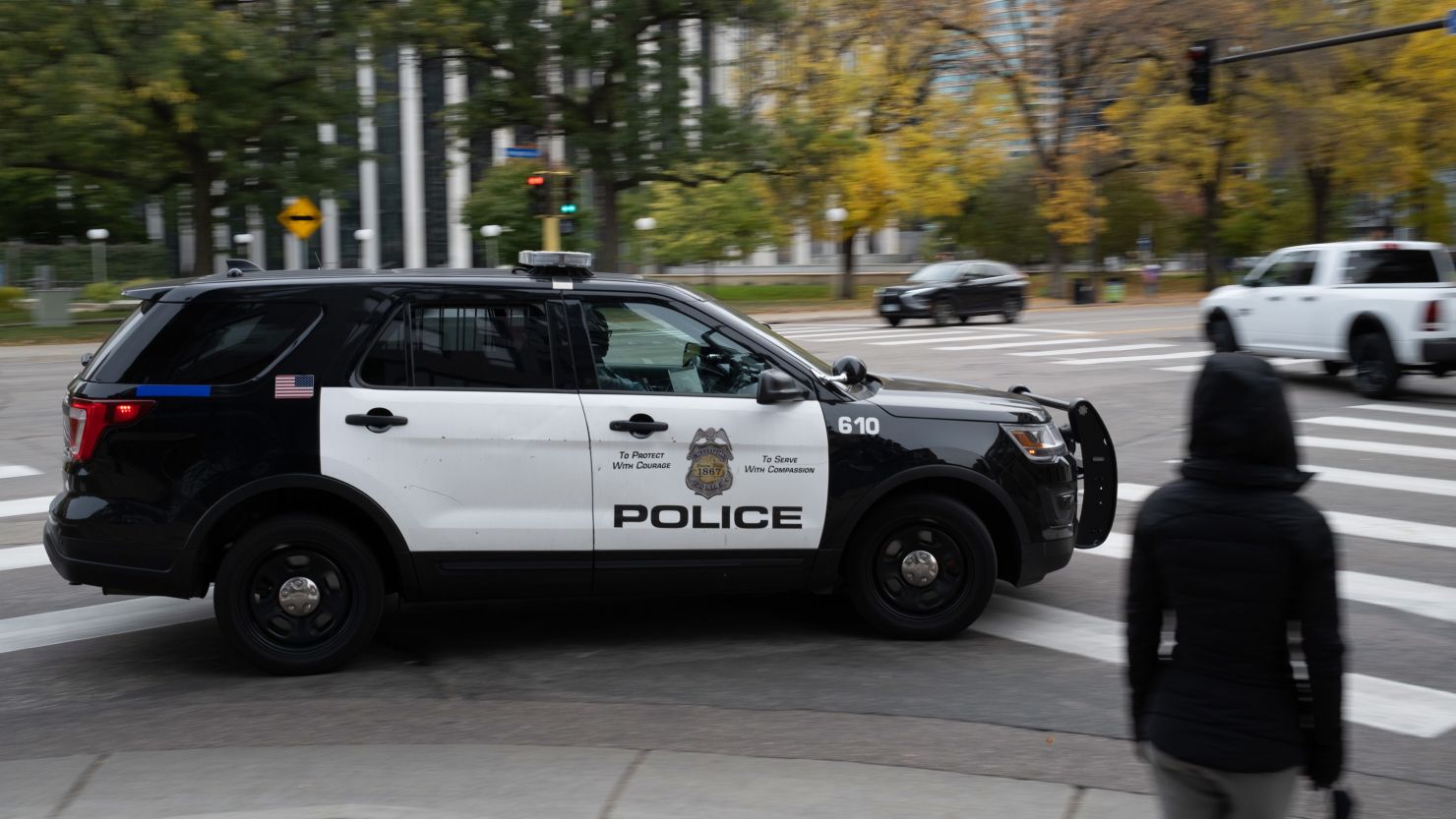 A police vehicle travels in downtown Minneapolis on Sunday, Oct. 24, 2021. More than a year after George Floyd was killed, voters in Minneapolis are about to decide on a mayor, every member of the city council  and a measure to overhaul the police department.
