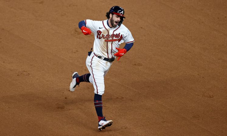 Braves shortstop Dansby Swanson celebrates as he rounds the bases after <a href="index.php?page=&url=https%3A%2F%2Fwww.cnn.com%2Fsport%2Flive-news%2Fworld-series-2021-braves-astros-game-4%2Fh_4cc1f72398e49ba18e2c8084d3ab28c4" target="_blank">hitting a home run</a> to tie the game in the seventh inning. It was his first homer of the 2021 postseason.