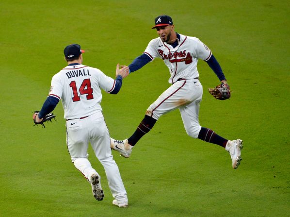 Adam Duvall and Eddie Rosario of the Atlanta Braves celebrate in the eighth inning after Rosario <a href="index.php?page=&url=https%3A%2F%2Fwww.cnn.com%2Fsport%2Flive-news%2Fworld-series-2021-braves-astros-game-4%2Fh_8e83ad53c8de208644674fa5db190371" target="_blank">caught a fly ball</a> hit by the Astros' Jose Altuve.