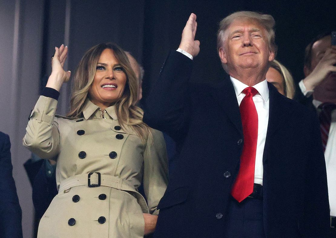 Former first lady and president of the United States Melania and Donald Trump do the "Tomahawk chop" prior to Game Four of the World Series between the Houston Astros and the Atlanta Braves on Saturday at Truist Park in suburban Atlanta.