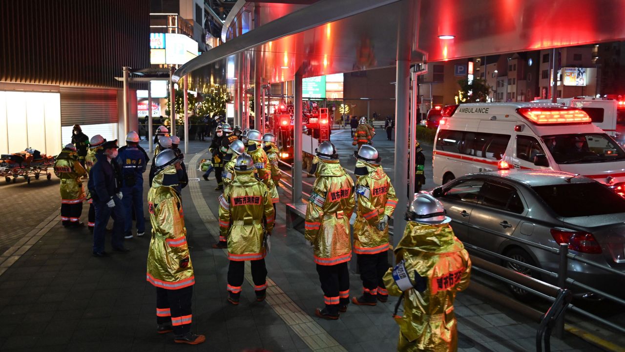 Firefighters gather outside Kokuryo Station on the Keio Line in the city of Chofu in western Tokyo on October 31, 2021.