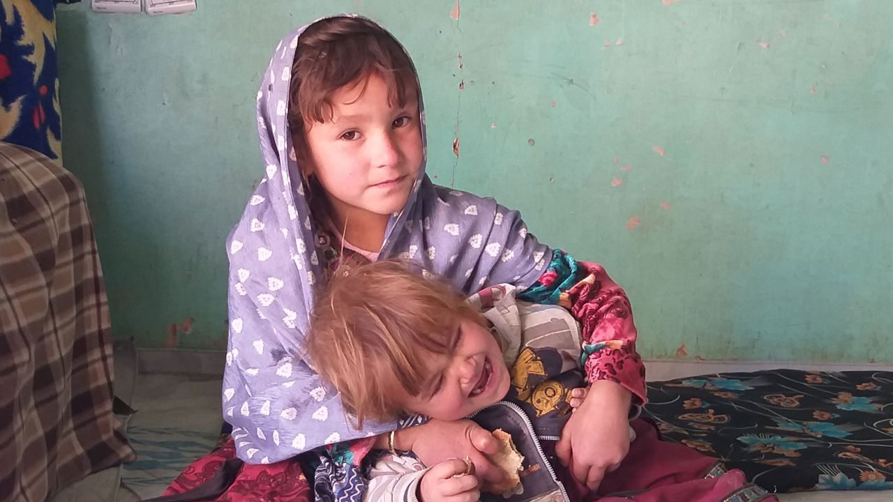 Zaiton, 4, plays with her brother at their home in Ghor province, Afghanistan.
