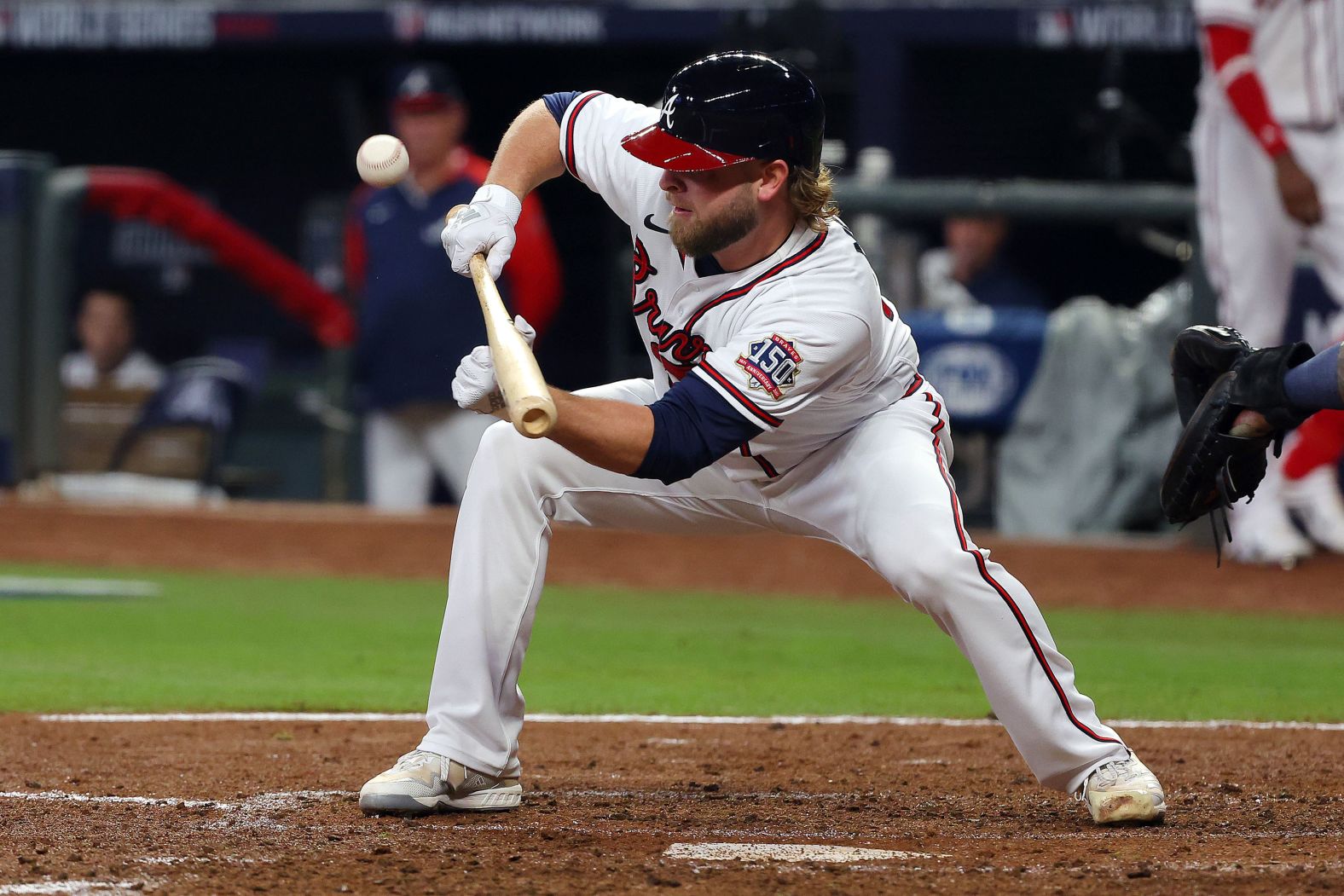 Braves pitcher A.J. Minter bunts during the fourth inning on Sunday.