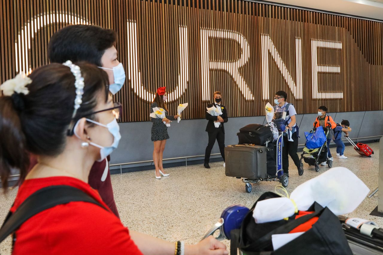 Recently arrived international travellers walk through the Melbourne Airport International arrivals hall on November 1, 2021 in Melbourne, Australia.