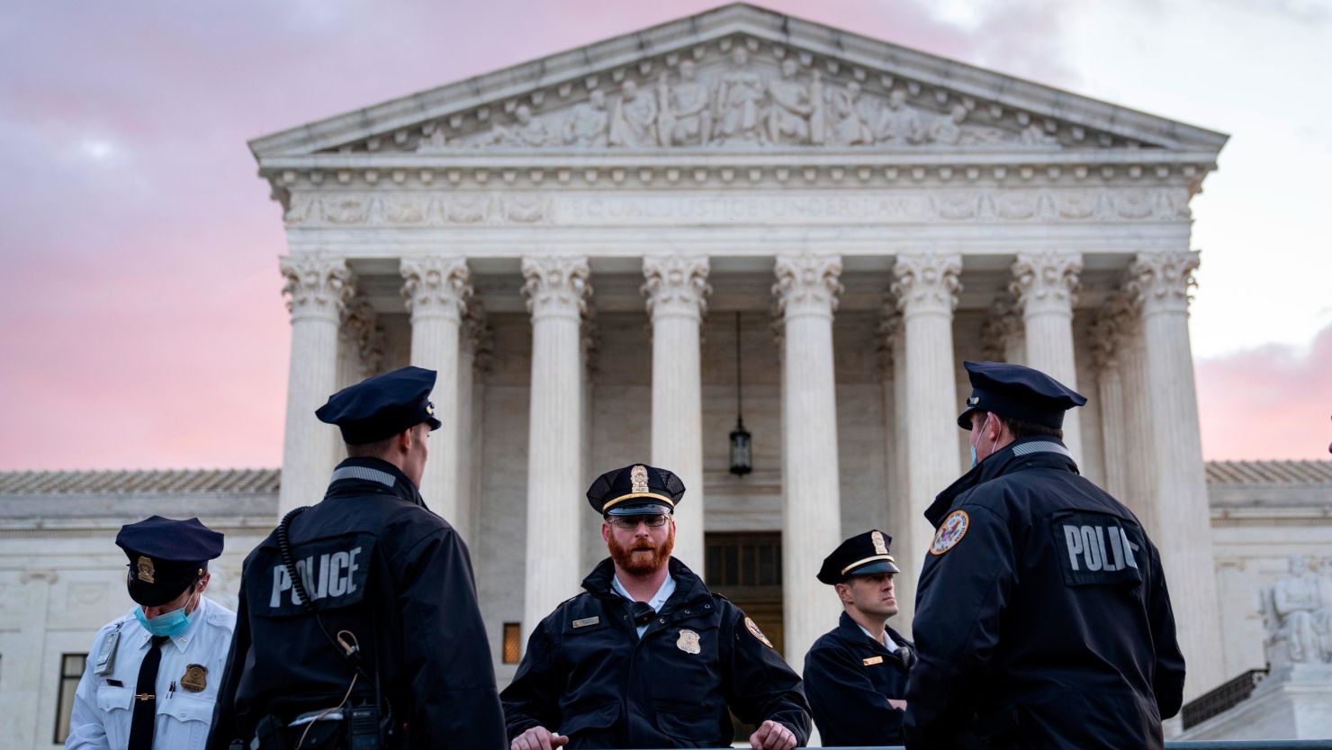 In this November 1, 2021, file photo, Supreme Court police officers set up security barricades outside the US Supreme Court building before the justices hear arguments in a challenge to a controversial Texas abortion law.