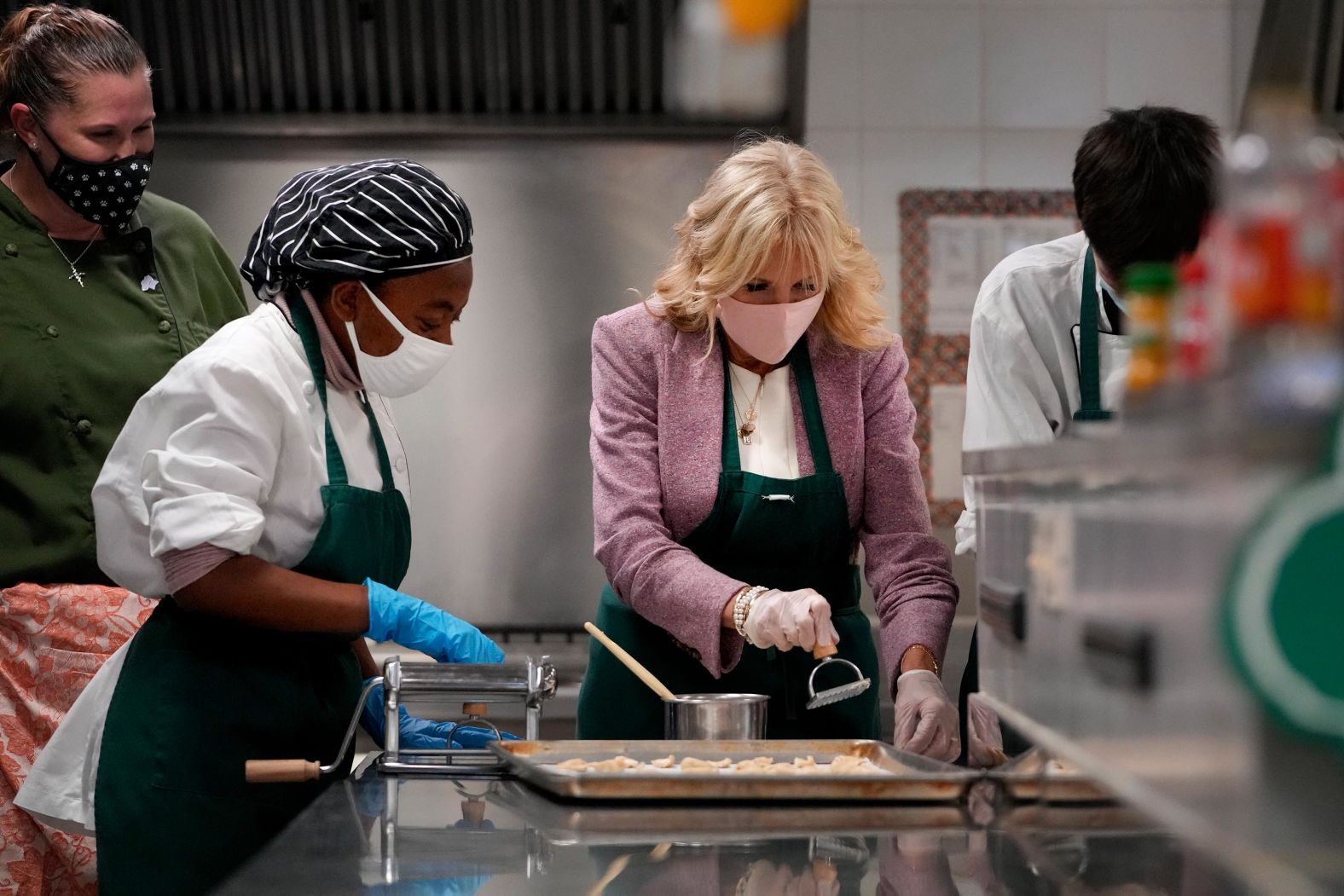 Jill Biden, center, helps make ravioli in a culinary class as she visits Naples Middle/High School, a Department of Defense Education Activity school in Italy.