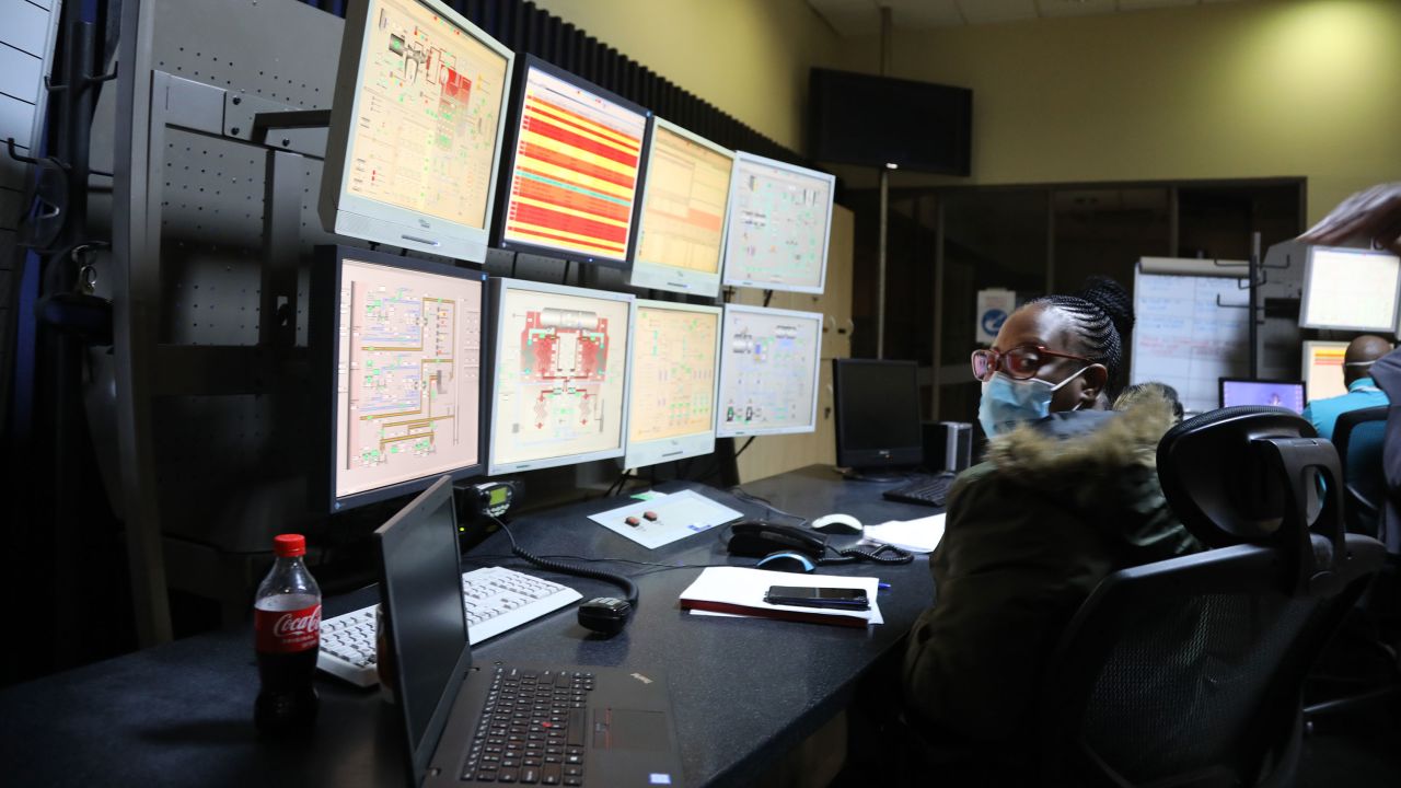 A Komati power station employee monitors multiple screens at the control room. Nearly 90% of South Africa's power generation is fueled by coal.