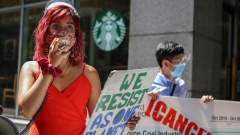 Mitzi Jonelle Tan, a Filipino climate activist, speaks during a protest in front of a Standard Chartered bank office in the financial district of Makati in Manila, Philippines.