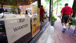 A restaurant storefront on Middle Neck Road has a "Help Wanted" sign in a window.