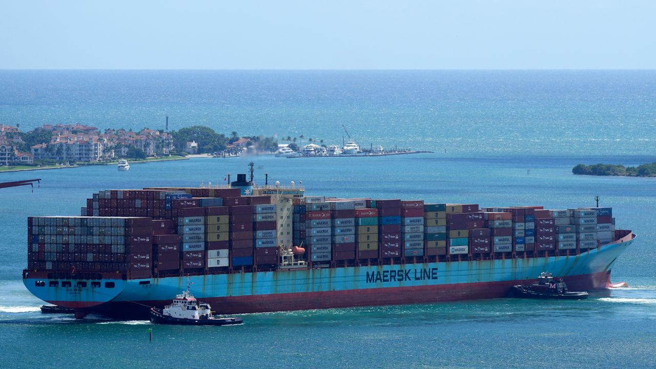 Tugboats work together to rotate the Axel Maersk container ship as it arrives in Miami.