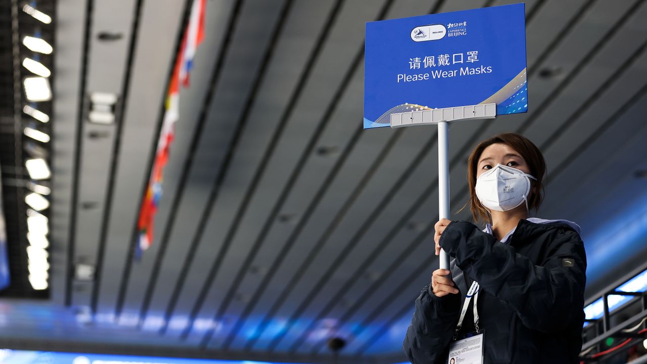 A volunteer holds up a sign during a test event for the Beijing 2022 Winter Olympics on October 21 in Beijing, China.