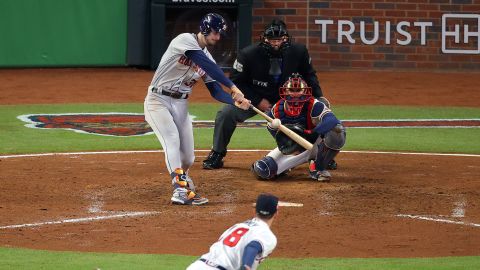 The Astros' Kyle Tucker of the hits a double against Drew Smyly of the Braves in the seventh in Game 5.