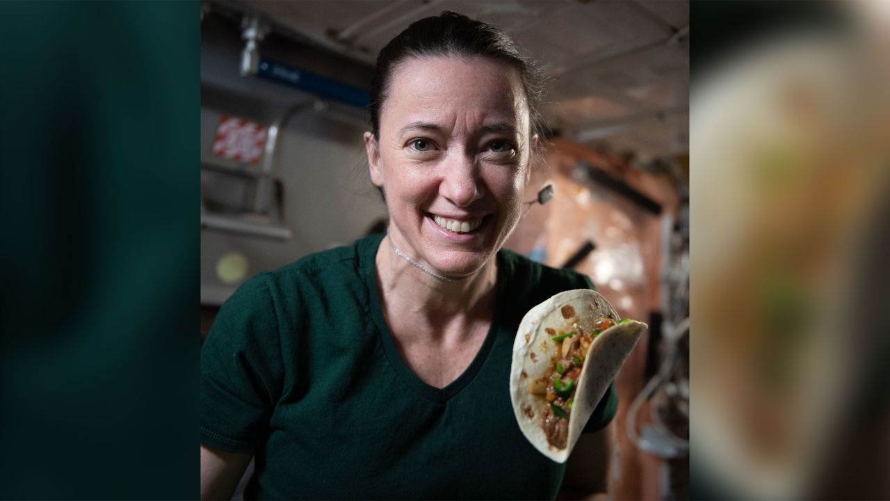 NASA astronaut Megan McArthur is seen with a taco made using fajita beef, rehydrated tomatoes and artichokes, and chile peppers. 