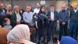 Palestinian activist Muna al-Kurd, center, stands with her neighbors at a press conference in the Sheikh Jarrah neighborhood of east Jerusalem, Tuesday, Nov. 2, 2021. Palestinian families in the tense neighborhood of Jerusalem have rejected an offer that would have delayed their eviction by Jewish settlers. In a statement on Tuesday, the four families said their decision springs from "our belief in the justice of our cause and our right to our homes and our homeland." (AP Photo/Mahmoud Illean)