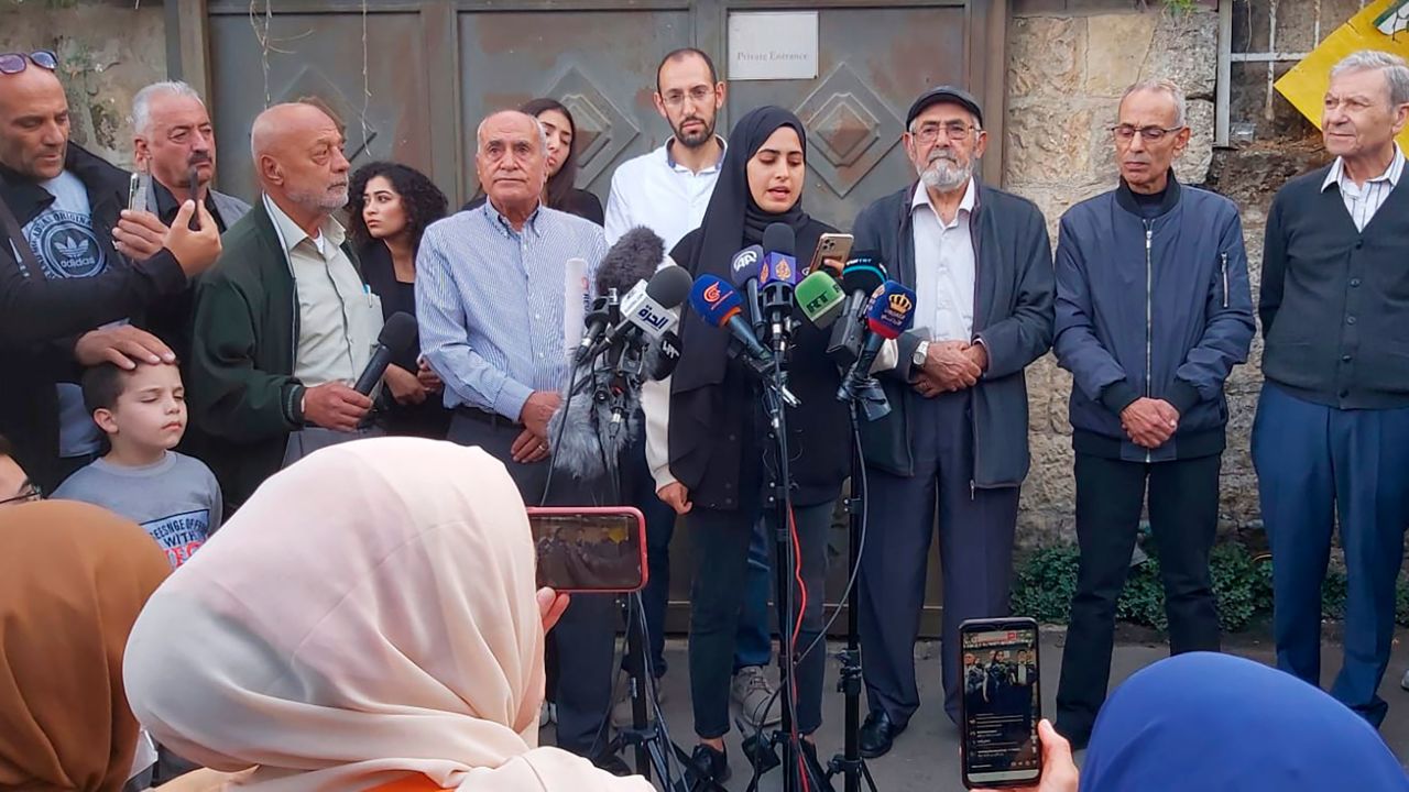 Palestinian activist Muna al-Kurd, center, stands with her neighbors at a press conference in Sheikh Jarrah on Tuesday.