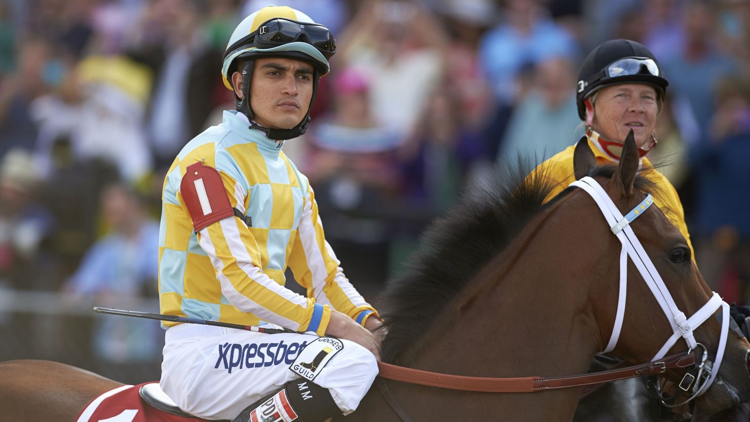 Miguel Mena (L) aboard Bayern before the 139th Preakness Stakes race at Pimlico Race Course in 2014.