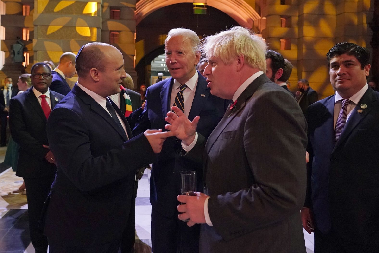 Biden chats with Israeli Prime Minister Naftali Bennett, left, and British Prime Minister Boris Johnson during an evening reception on Monday.