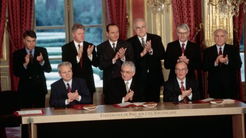 Seated from left, Serbian President Slobodan Milosevic, Croat President Franjo Tudjman and Bosnian President Alija Izetbegovic with the freshly-signed Dayton Peace Agreement in Paris in 1995.