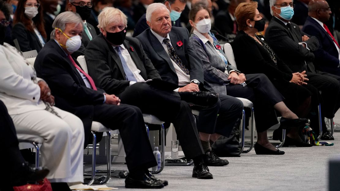 British broadcaster and naturalist David Attenborough, center, sits next to British Prime Minister Boris Johnson at the COP26 climate summit in Glasgow.