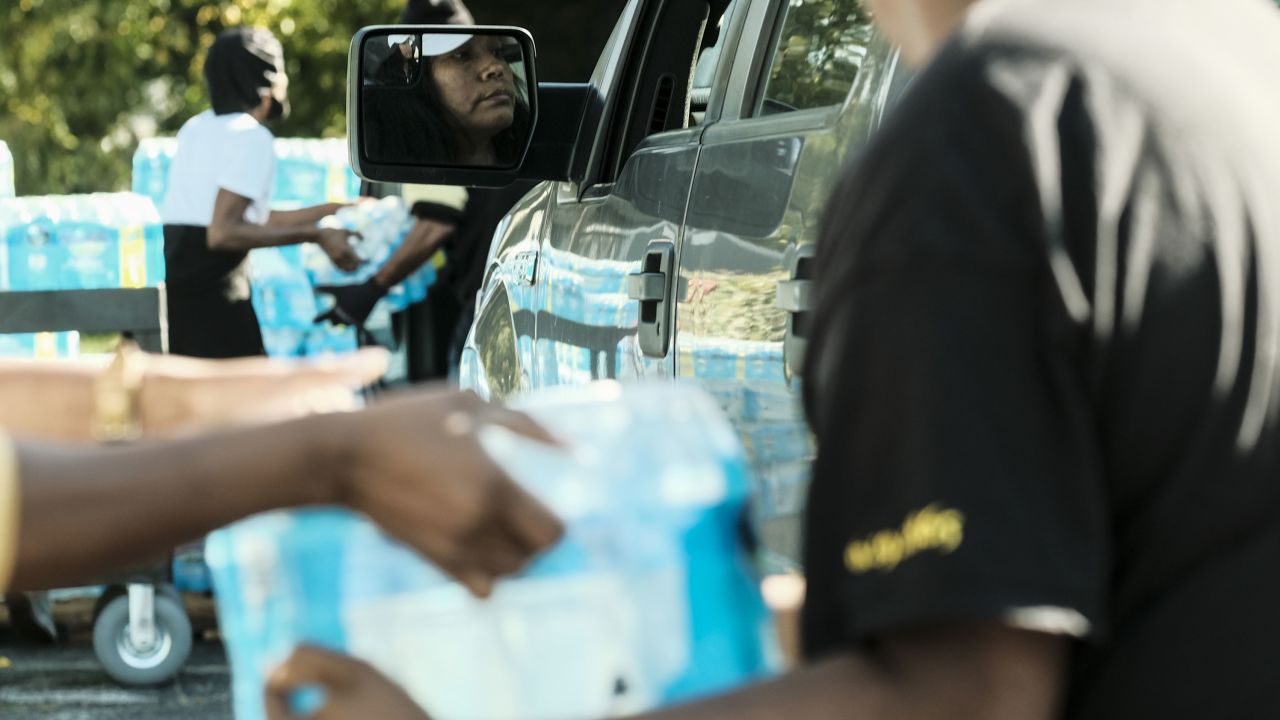 Volunteers distribute bottled water to residents at the Abundant Life Church of God in Benton Harbor, Michigan, on Tuesday, October 19.