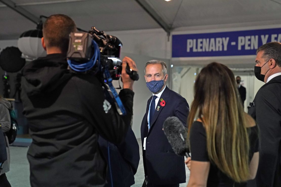 Mark Carney speaks to a TV crew in Glasgow on Nov. 3, 2021.