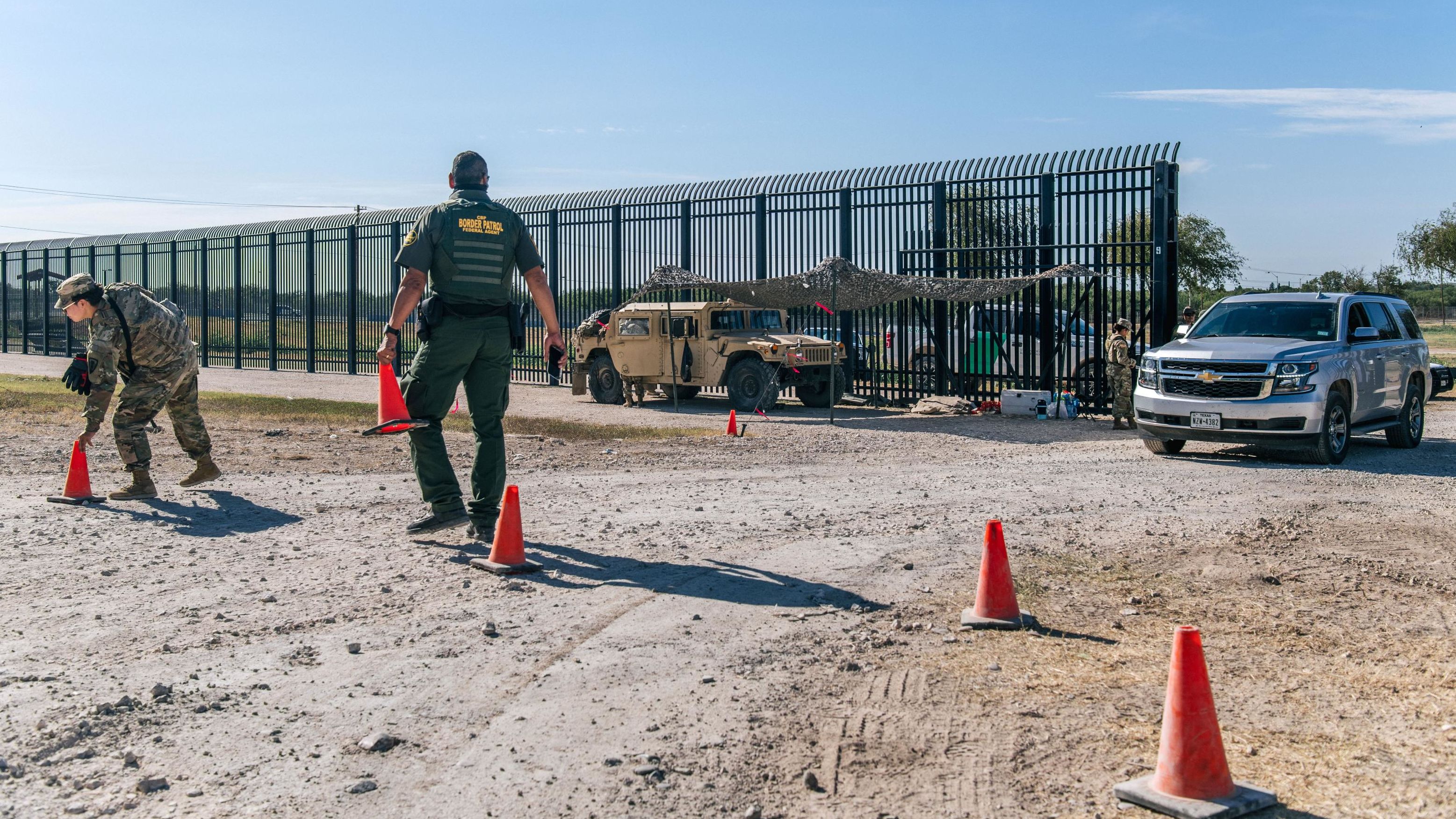 Border Patrol agents and members of the National Guard patrol a checkpoint entry near the Del Rio International Bridge on September 22, 2021 in Del Rio, Texas. 