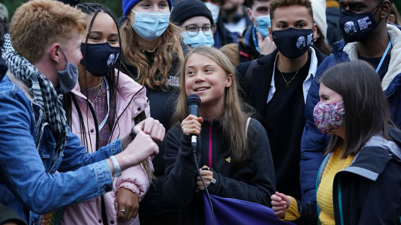 Greta Thunberg, surrounded by other climate protesters on Monday