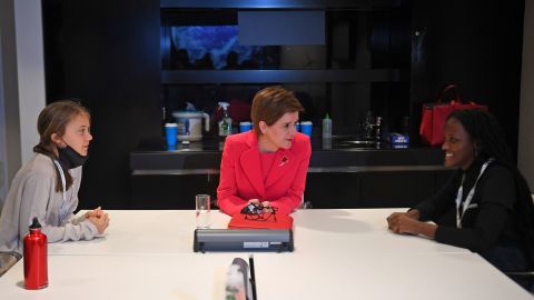 Scotland's First Minister, Nicola Sturgeon, center, talks with climate activists Vanessa Nakate, right, and Greta Thunberg, left, during the COP26 conference.