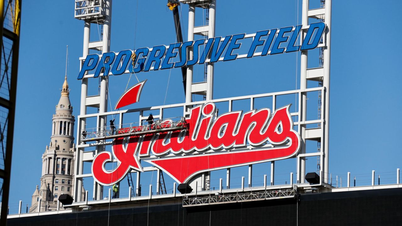 Workers begin to remove the Cleveland Indians sign from above the scoreboard at Progressive Field.
