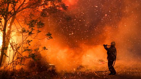 A firefighter battles flames in Cordoba, Argentina, in October 2020. Wildfires have destroyed thousands of hectares in the Argentine province of Cordoba this year, amid a drought and high temperatures.