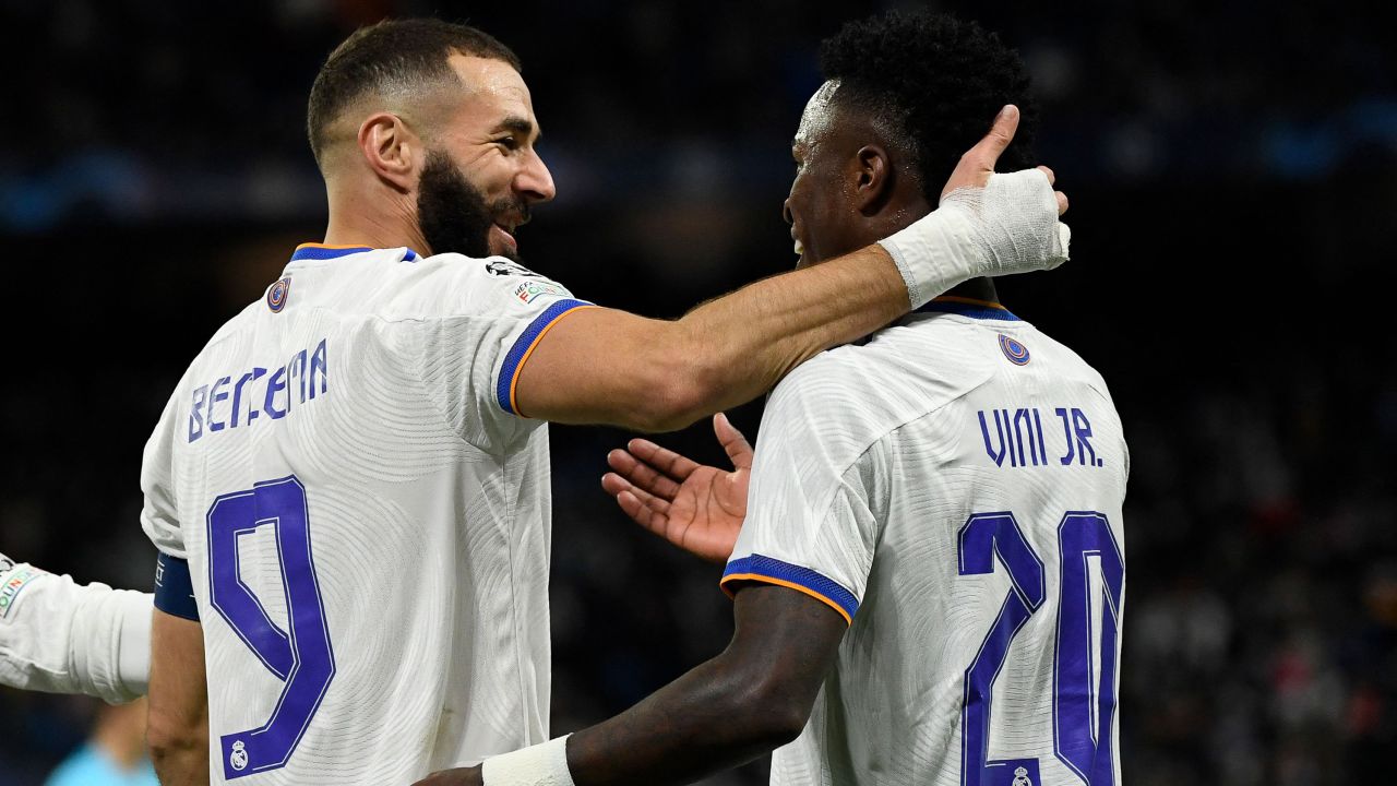 Benzema (left) celebrates with Vinicius Junior after scoring his team's second goal.