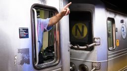 A conductor in a train points to a sign at a subway station in New York, U.S., on Friday, July 2, 2021. New York's Metropolitan Transportation Authority needs more riders to help support a record $51.5 billion capital plan to expand service throughout the New York City region and modernize its infrastructure. Photographer: Mark Kauzlarich/Bloomberg via Getty Images