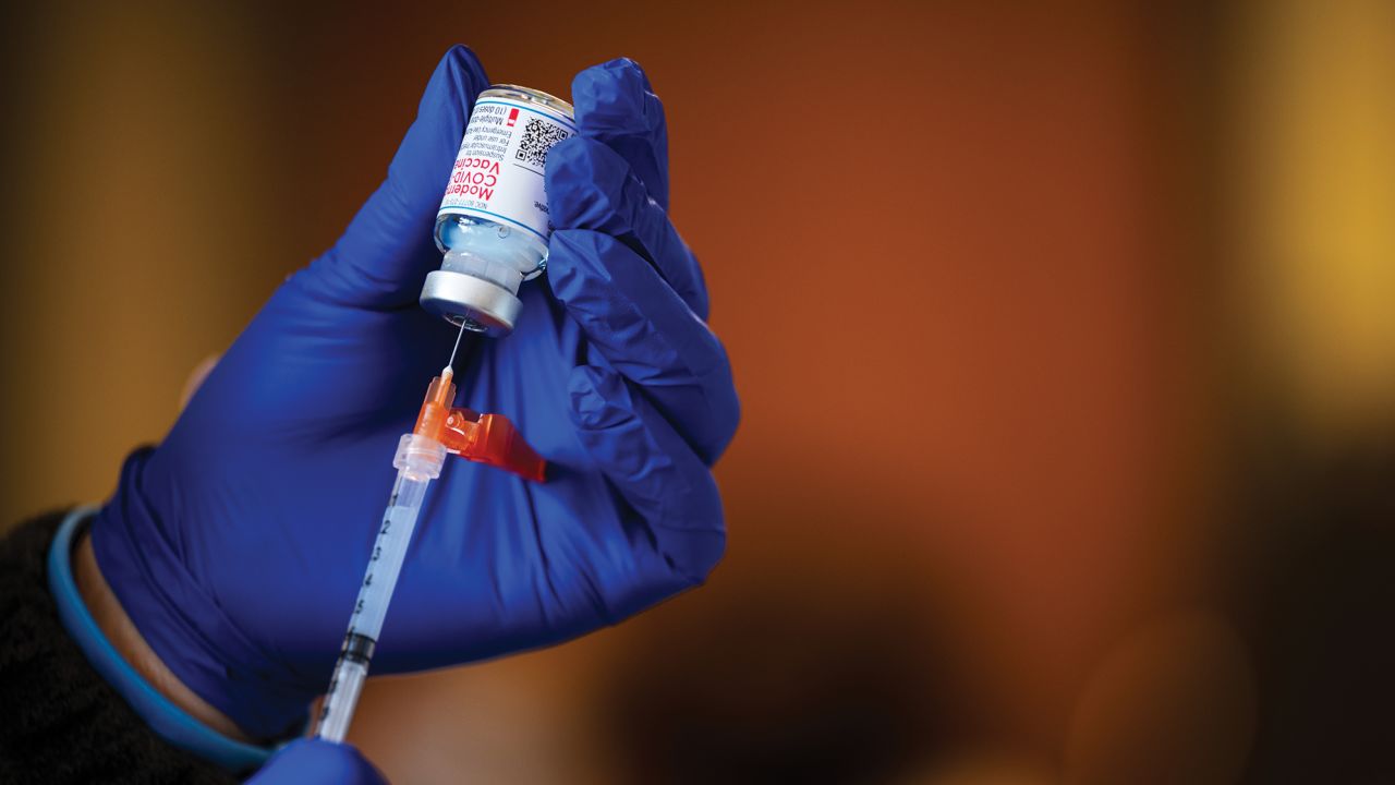 A medical technician fills a syringe from a vial of the Moderna COVID-19 vaccine in Bates Memorial Baptist Church February 12, 2021 in Louisville, Kentucky. 