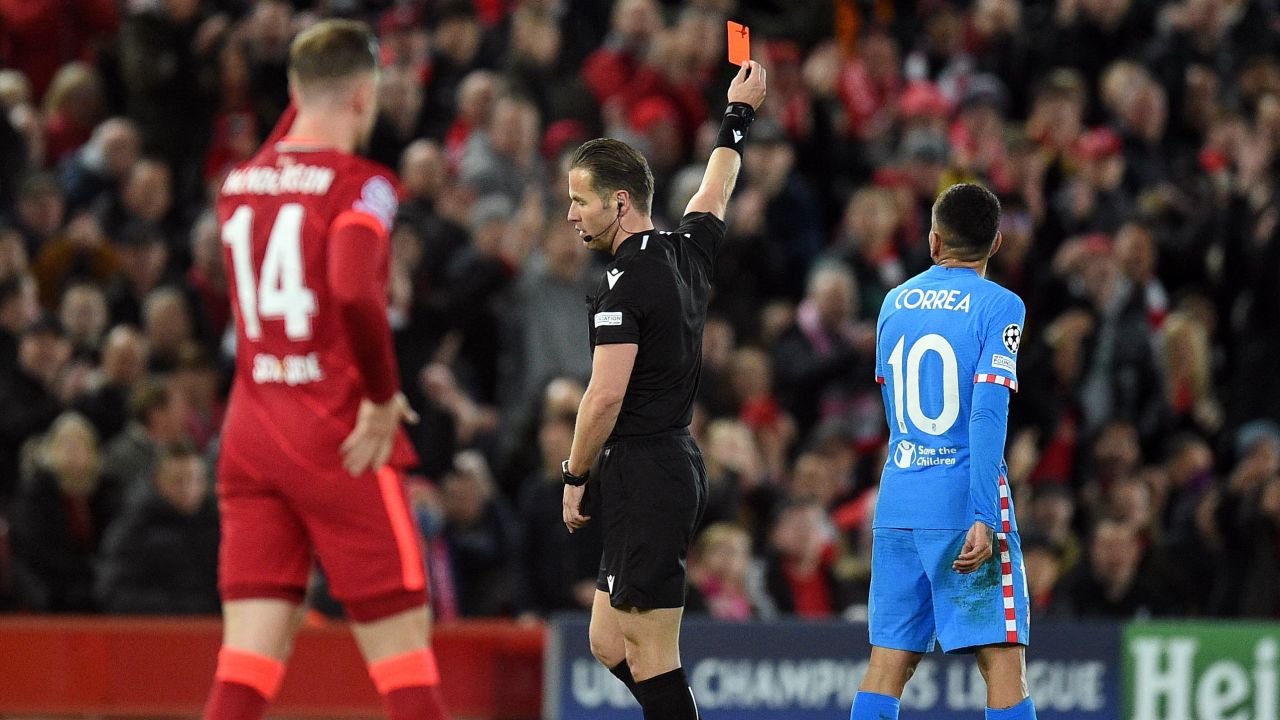 Referee Danny Makkelie shows a red card to Atletico Madrid's Felipe (unseen).