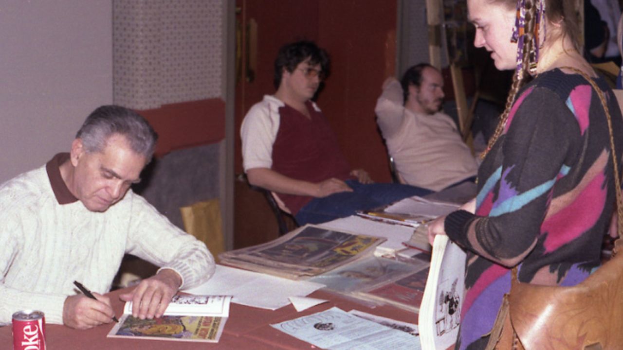 Jack Kirby signs a comic for Diana Schutz at the Hilton San Francisco Union Square in 1982.