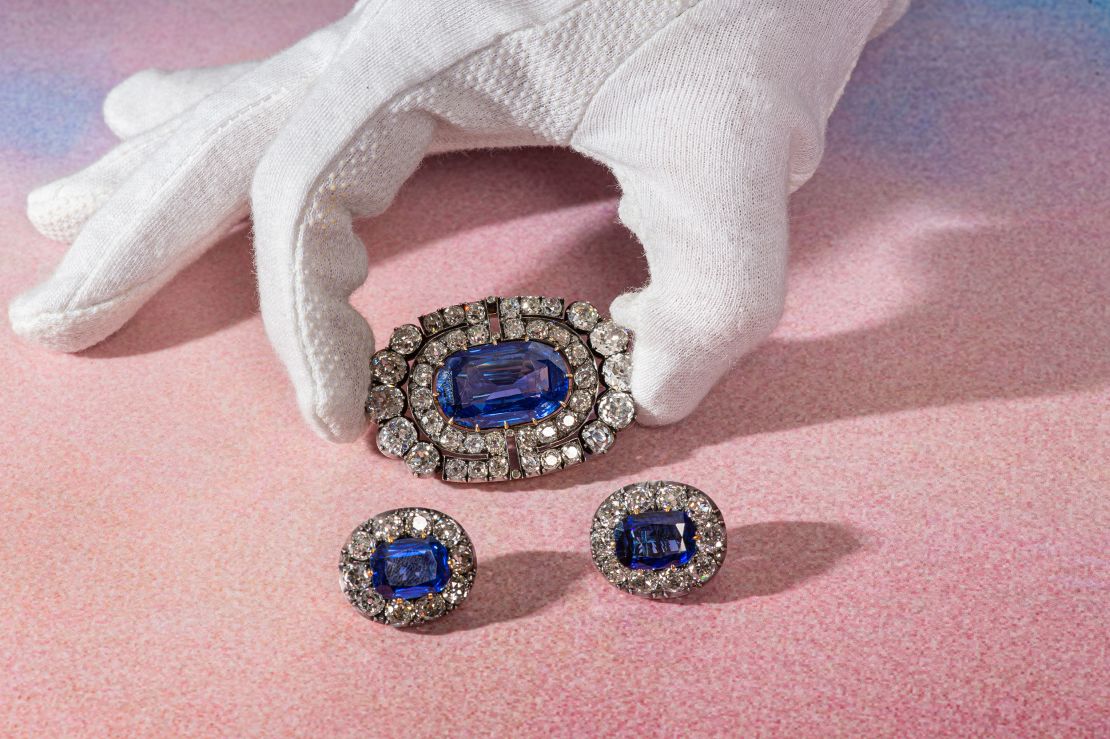 A sapphire and diamond brooch and a pair of ear clips which date from circa 1900.