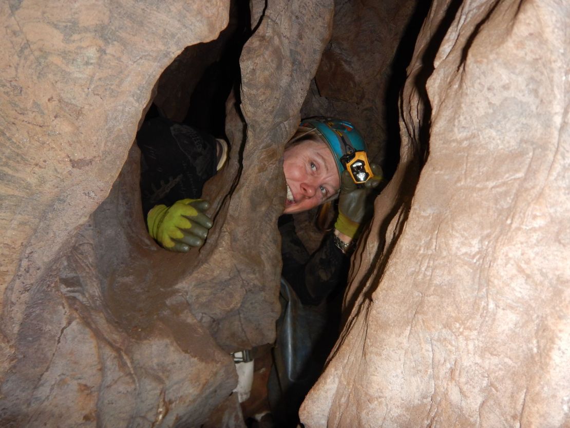 Marina Elliott is shown exploring the Rising Star cave system.