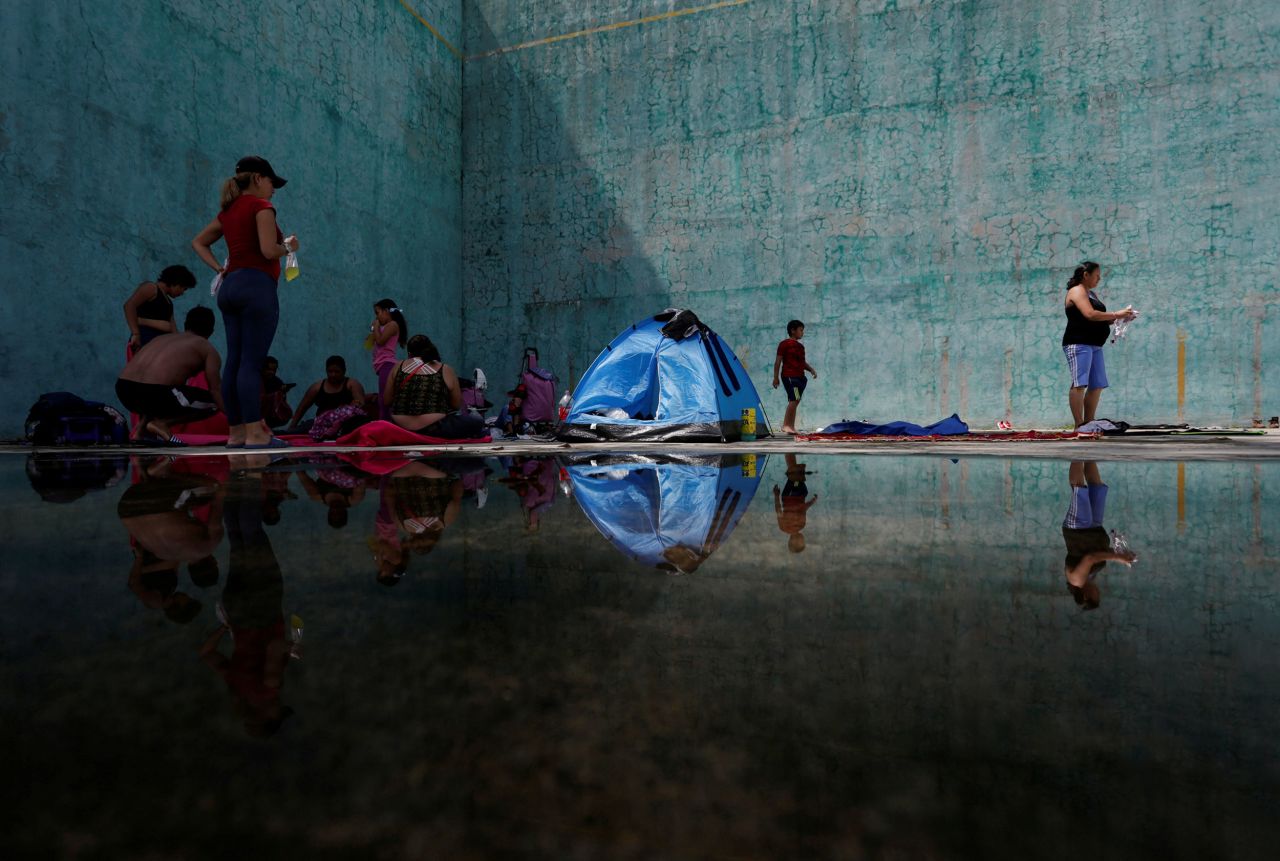 Migrants traveling in a caravan to Mexico City rest in a jai-alai court in Acacoyagua, Mexico, on Friday, October 29.