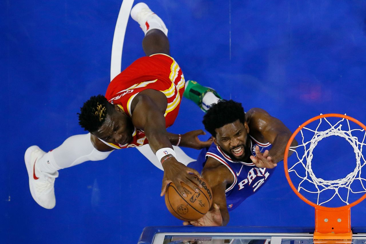 Atlanta Hawks' Clint Capela, left, blocks a shot by Philadelphia 76ers' Joel Embiid during a game on Saturday, October 30, in Philadelphia.