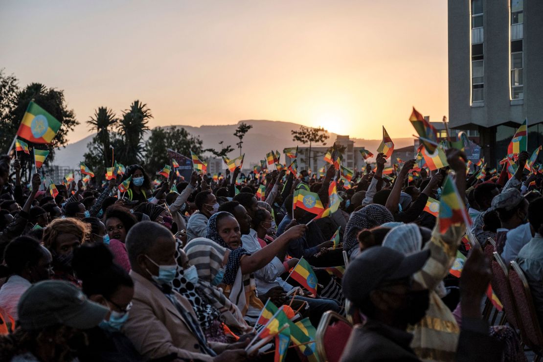 A crowd wave Ethiopian flags during a memorial service for the victims of the Tigray conflict organized by the city administration, in Addis Ababa on November 3.