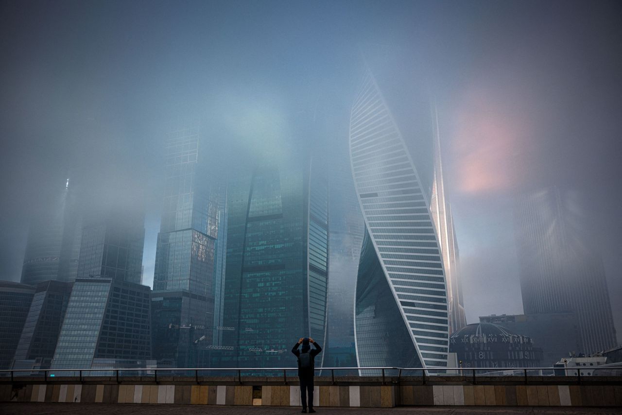 A person takes a photo of fog covered skyscrapers in Moscow, Russia, on Tuesday, November 2.