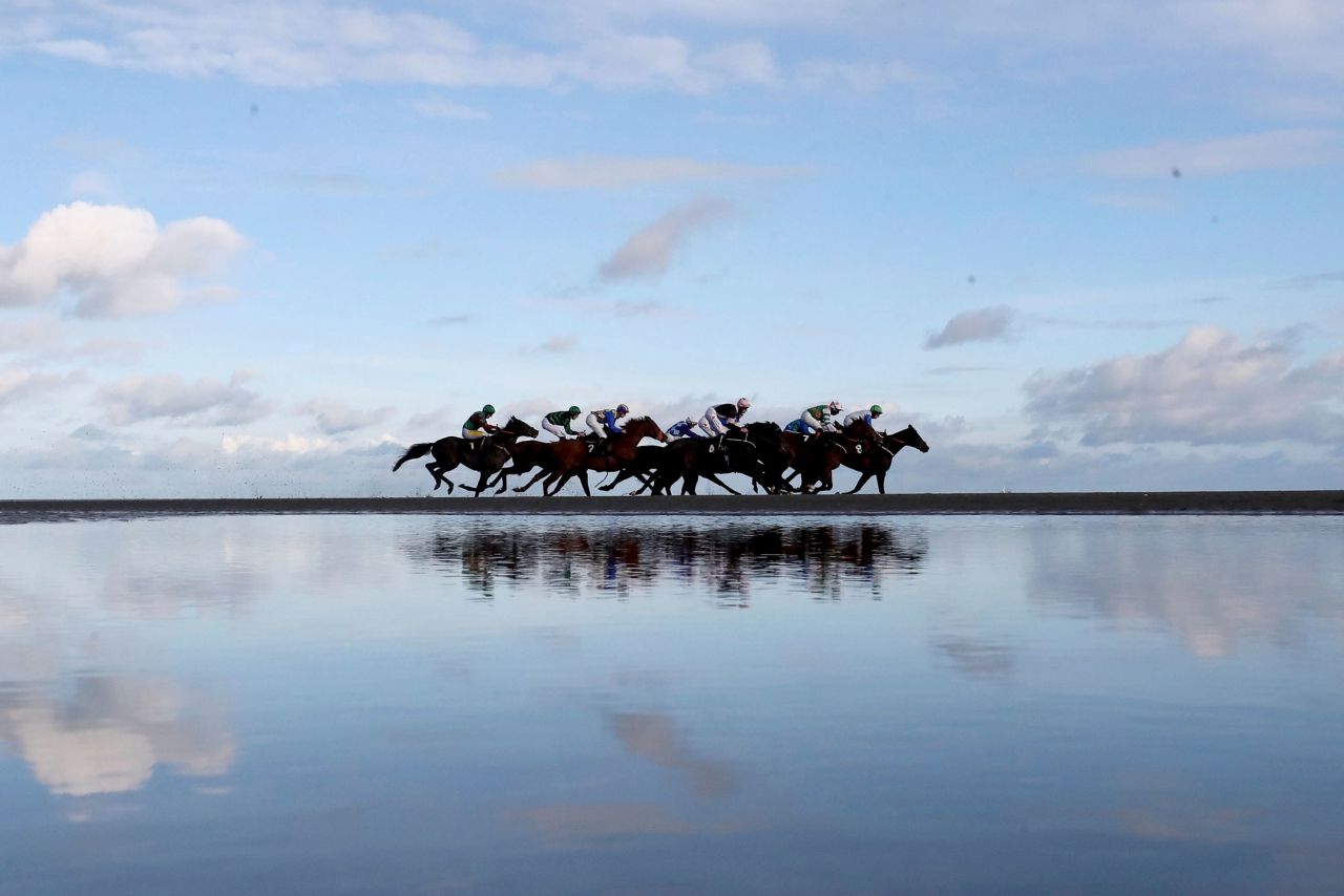 Jockeys ride their horses as they compete at a racecourse in Laytown, Ireland, on Monday, November 1.