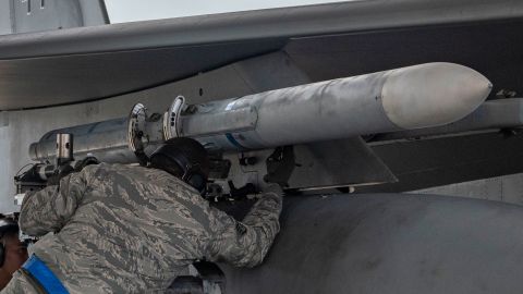 A US Air Force weapons load crew team attach an AIM-120 advanced medium-range air-to-air missile onto an F-15 Eagle in this library photo showing the type of being missile the US is planning to sell to Saudi Arabia.