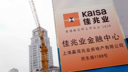 --FILE--View of a signboard of Kaisa Group Holdings Limited in Shanghai, China, 29 March 2017. Most founding bosses in the realty business hold total sway over their companies, especially in strategy. In top companies like Evergrande Real Estate Group and Country Garden Holdings, the bosses oversee strategy while presidents execute their instructions and manage daily operations. Bosses' short-term absences generally do not affect company operations, but if the owner is away too long this may inflict severe harm as the realty business is capital-intensive and debt-riddled, while most loan contracts contain mandatory provisions such as the "Owner or his/her family members must serve as the chairman of the board and exercise absolute control over the company."  (Imaginechina via AP Images)