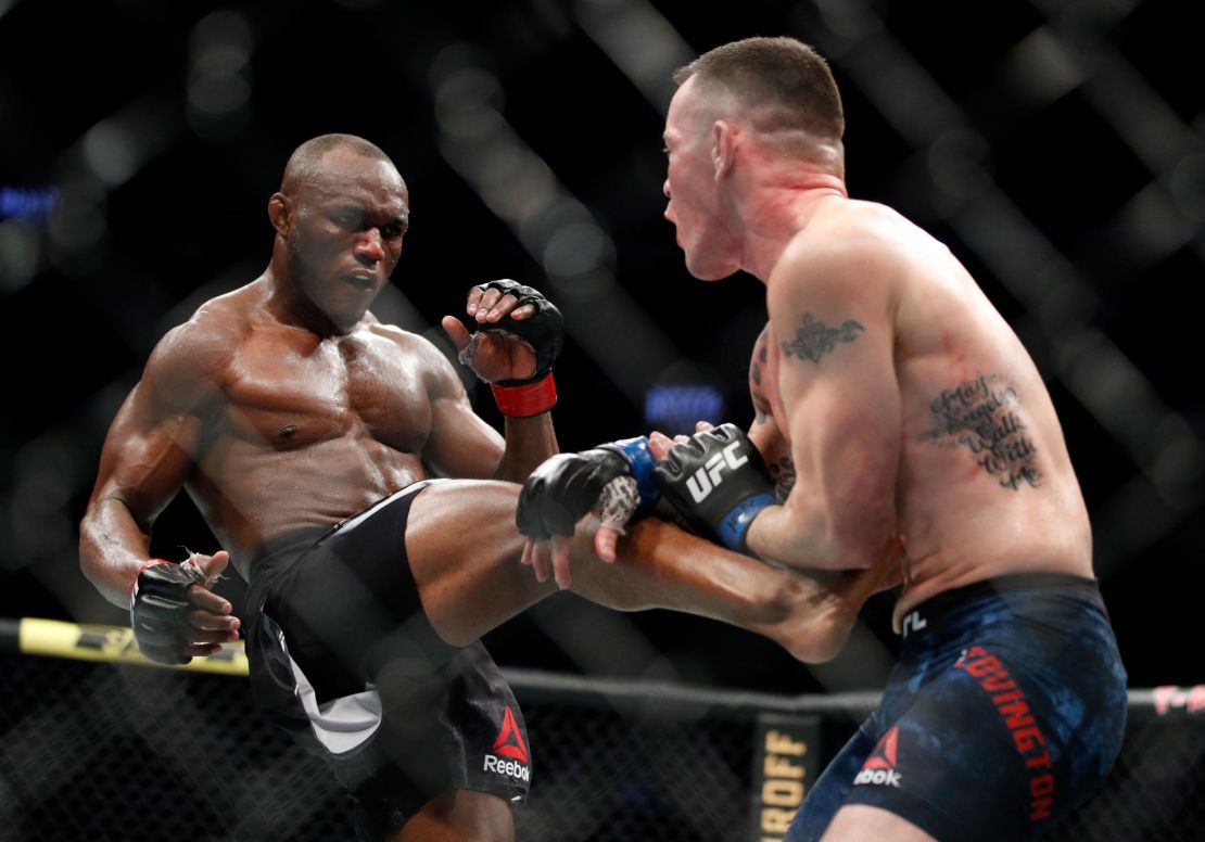 Usman kicks Covington during their first championship bout at UFC 245 in Las Vegas.
